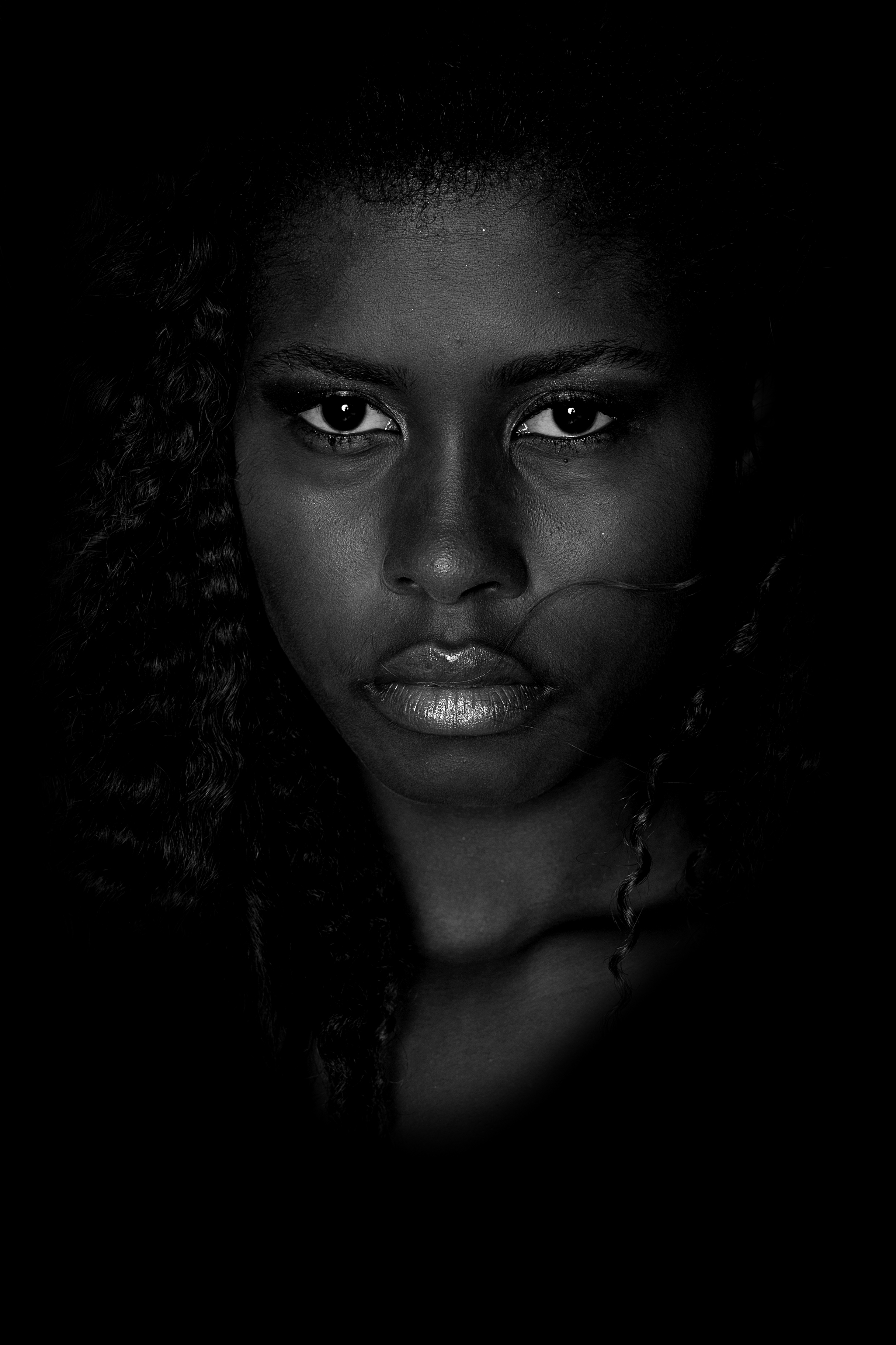 A girl's face in a black and white photo.
